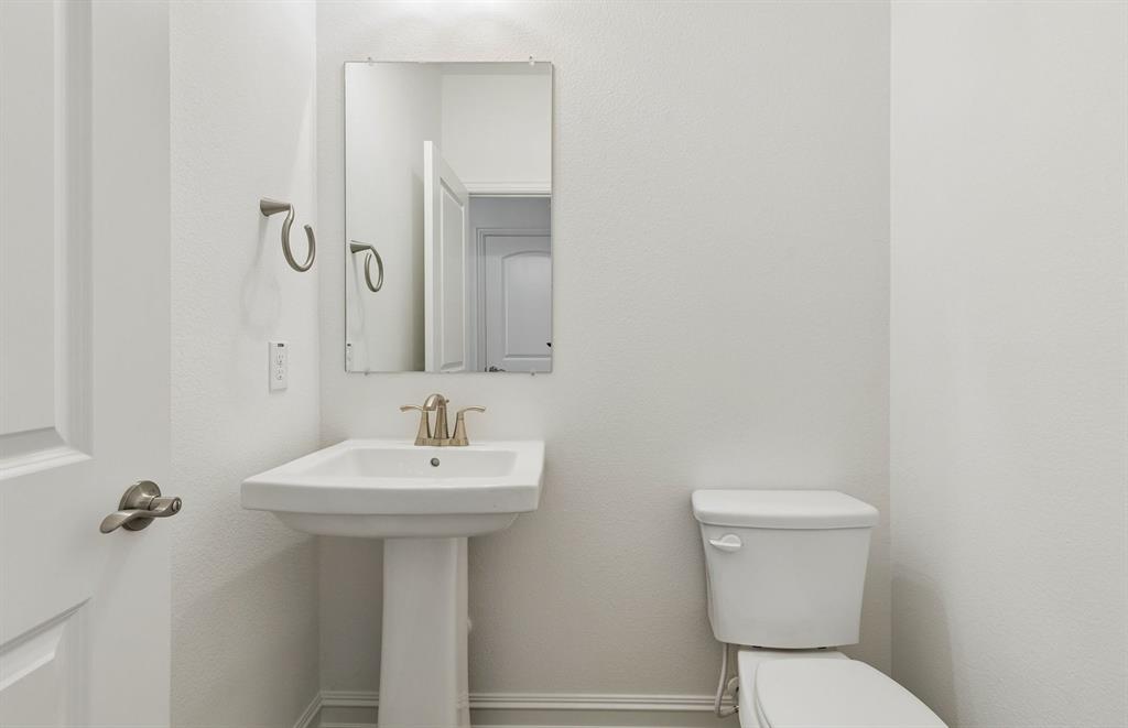 11220 Abbotsbury Road Fort Worth, TX 76052 - Photo 13 of 32 a bathroom with a sink a toilet and mirror