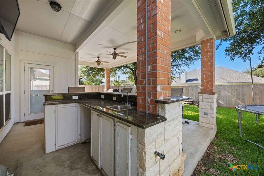 910 Neuberry Cliffe Temple, TX 76502 - Photo 24 of 32 a kitchen with a sink and stove top oven