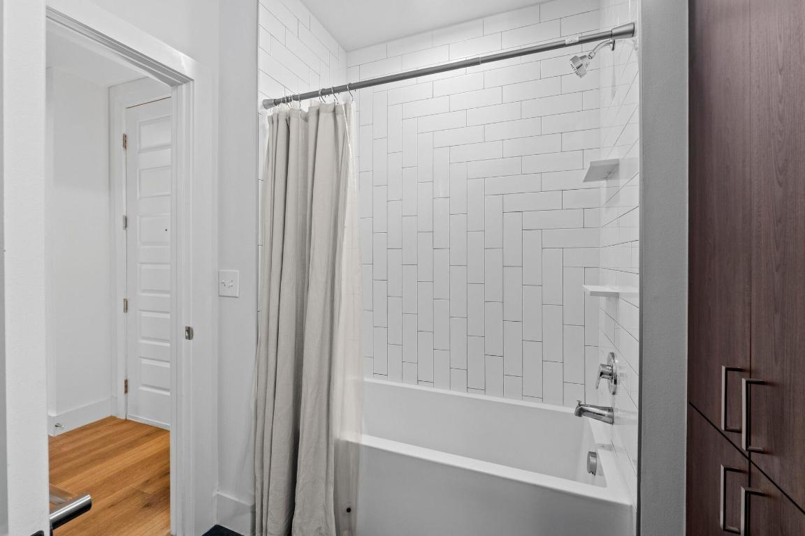 2213 Poquito Street, Unit 319 Austin, TX 78722 - Photo 19 of 22 a bathroom with a shower and a bath tub