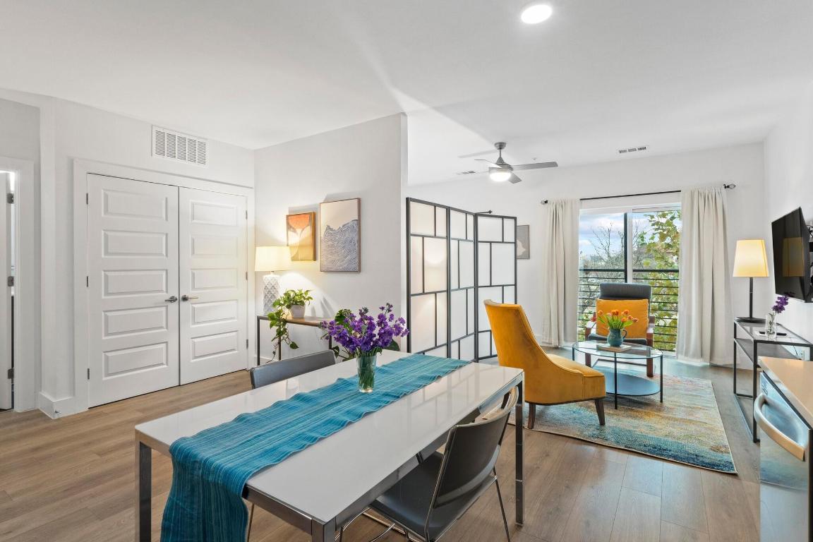 2213 Poquito Street, Unit 319 Austin, TX 78722 - Photo 2 of 22 a view of a dining room with furniture window and wooden floor