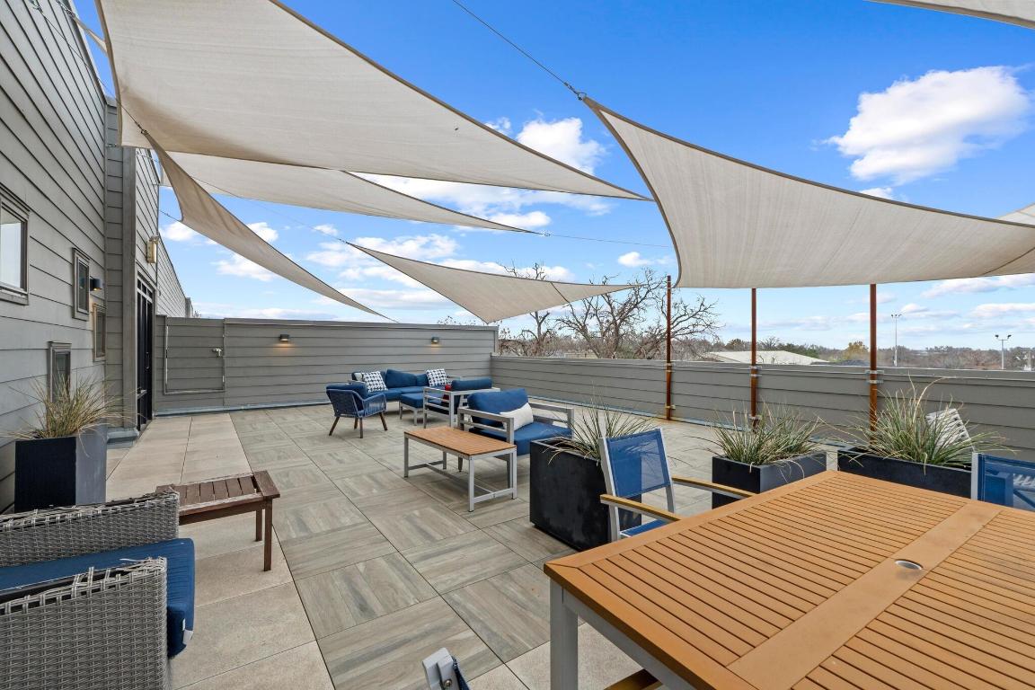 2213 Poquito Street, Unit 319 Austin, TX 78722 - Photo 22 of 22 a view of a patio with a table and chairs