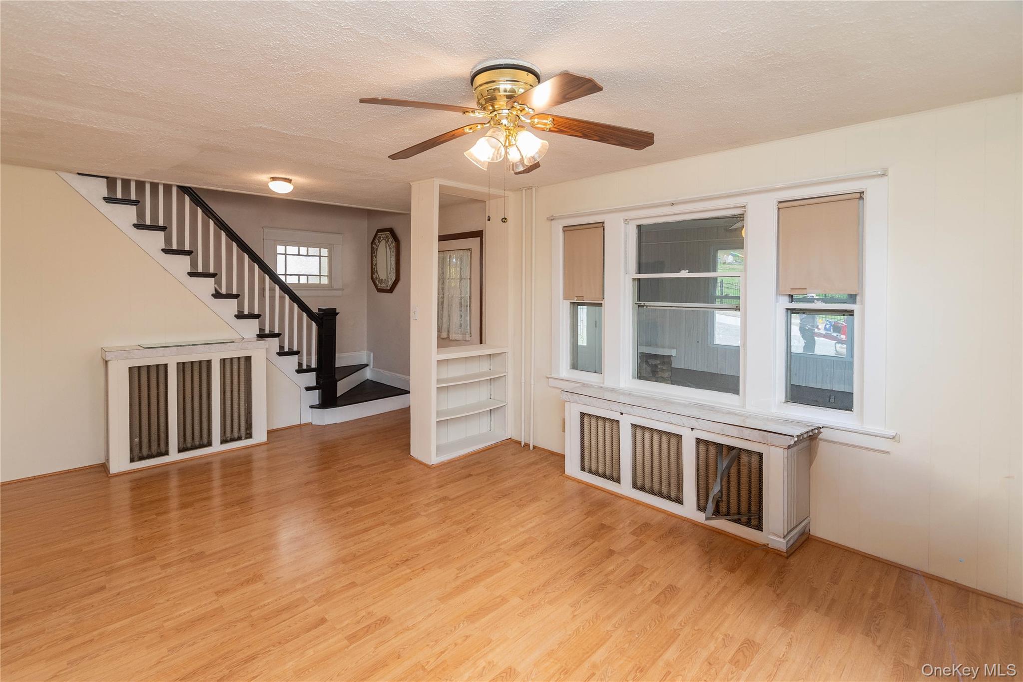 200 Husted Avenue Peekskill, NY 10566 - Photo 17 of 50 a view of an empty room with wooden floor and a ceiling fan