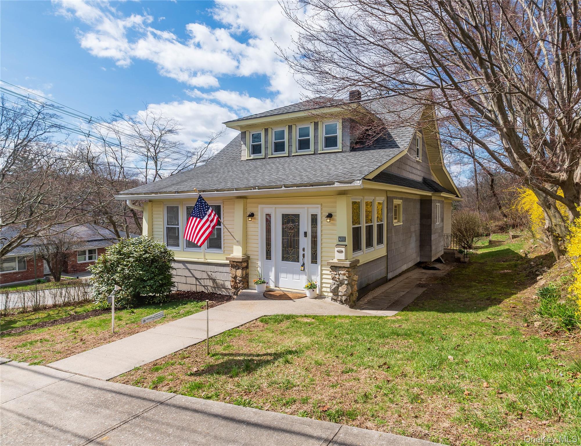 200 Husted Avenue Peekskill, NY 10566 - Photo 2 of 50 a view of a white house with large windows next to a yard