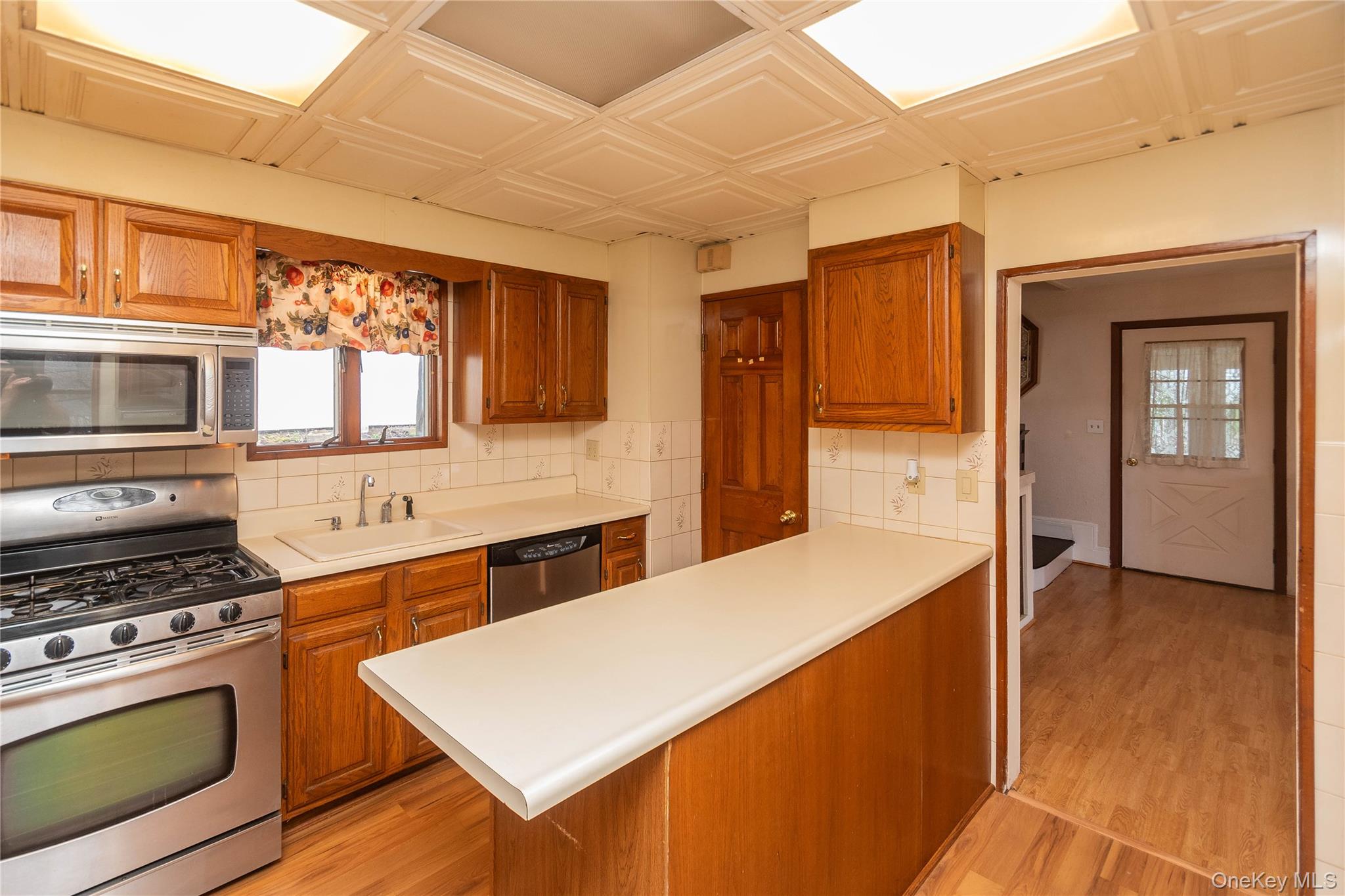 200 Husted Avenue Peekskill, NY 10566 - Photo 23 of 50 a kitchen with stainless steel appliances a stove a sink and a refrigerator