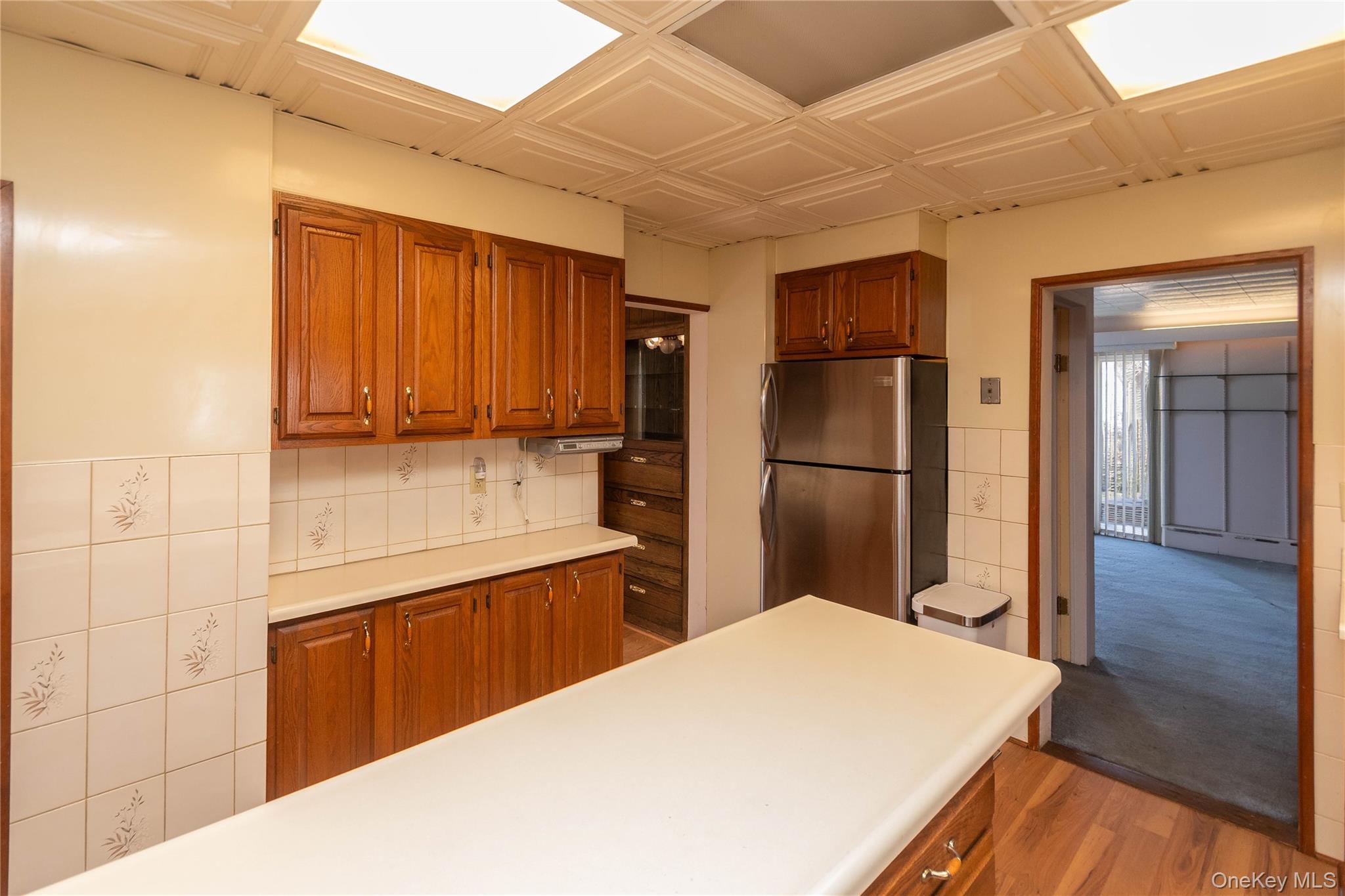 200 Husted Avenue Peekskill, NY 10566 - Photo 27 of 50 a kitchen with stainless steel appliances a refrigerator and wooden cabinets