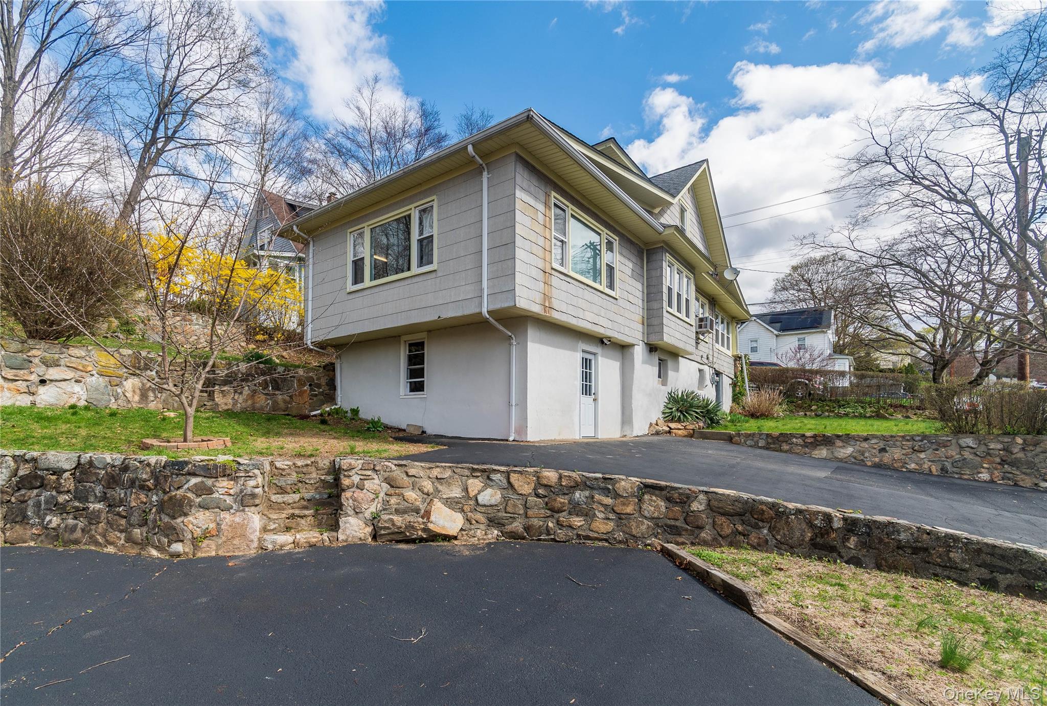 200 Husted Avenue Peekskill, NY 10566 - Photo 7 of 50 a front view of a house with a yard and garage