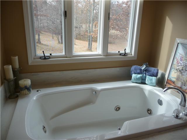 1250 Walter Head Road Adams, TN 37010 - Photo 11 of 20 a bath tub sitting in a bathroom next to a window