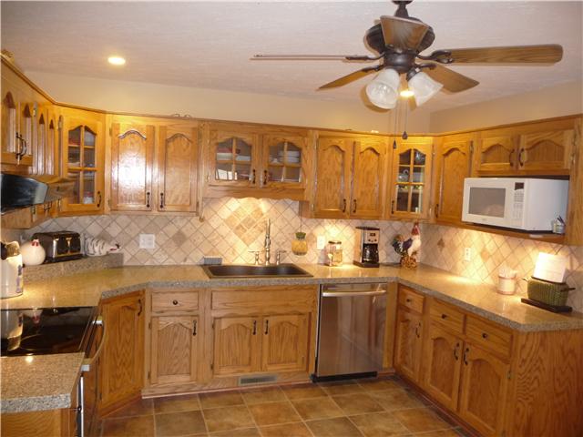 1250 Walter Head Road Adams, TN 37010 - Photo 6 of 20 a kitchen with a sink stainless steel appliances and cabinets