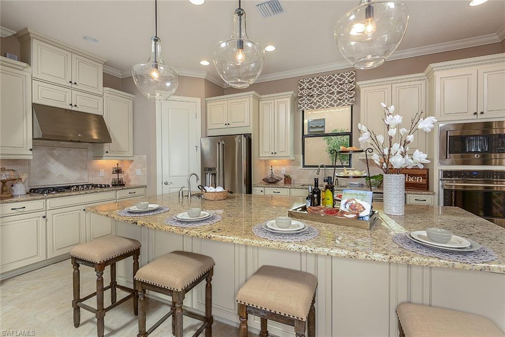 8558 Maggiore Court Naples, FL 34114 - Photo 11 of 32 a kitchen with refrigerator and cabinets