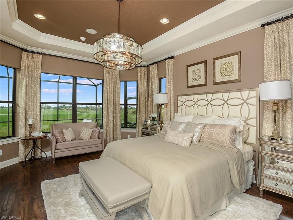 8558 Maggiore Court Naples, FL 34114 - Photo 14 of 32 a bedroom with a large bed and a chandelier