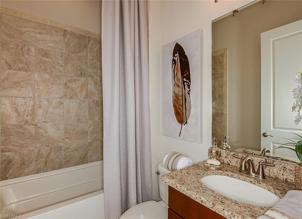 8558 Maggiore Court Naples, FL 34114 - Photo 19 of 32 a bathroom with a granite countertop sink and a mirror