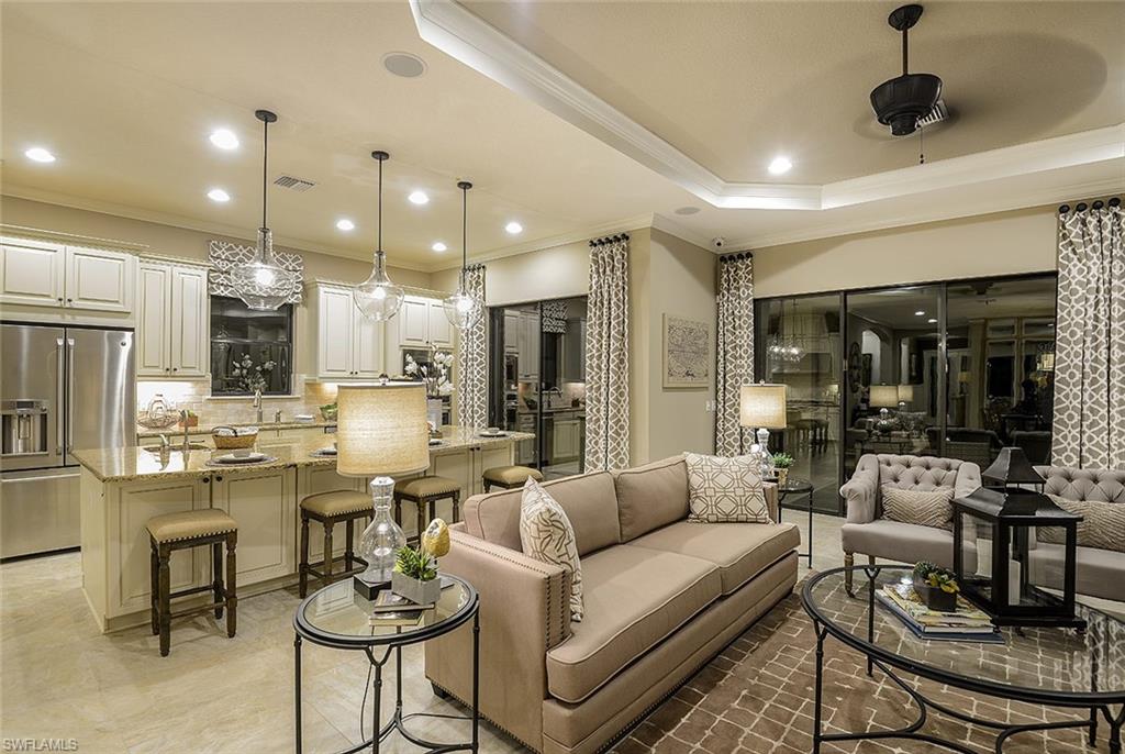 8558 Maggiore Court Naples, FL 34114 - Photo 2 of 32 a living room with lots of furniture and kitchen view