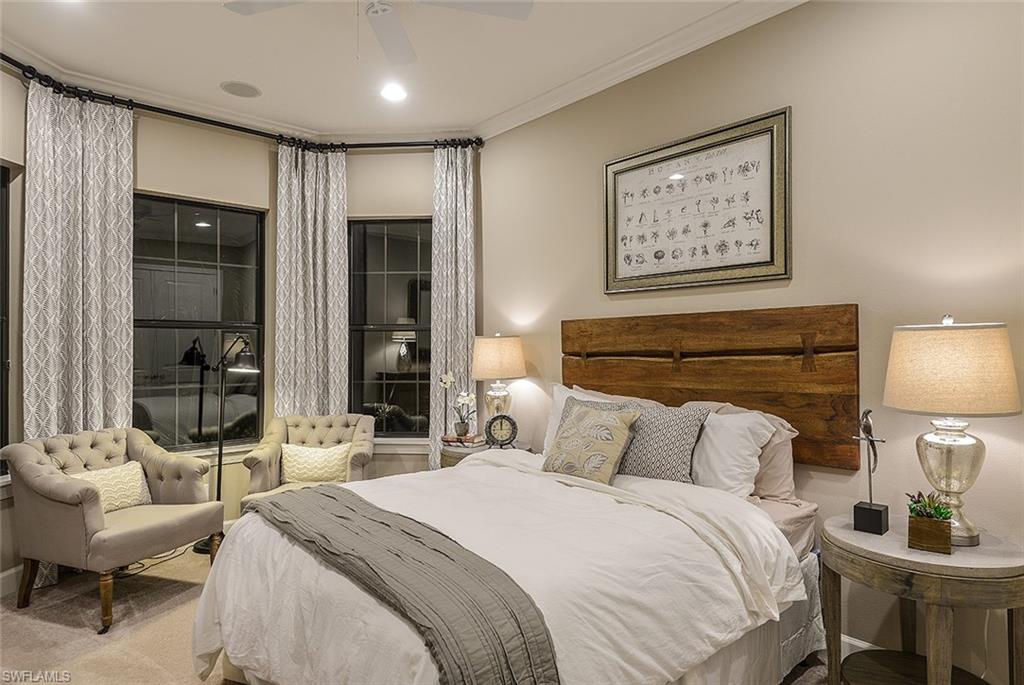 8558 Maggiore Court Naples, FL 34114 - Photo 5 of 32 a bedroom with a bed a mirror and a lamp on dresser