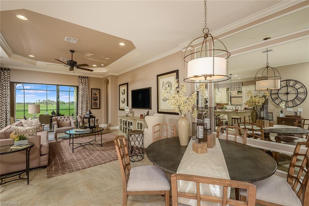 8558 Maggiore Court Naples, FL 34114 - Photo 9 of 32 a living room with lots of furniture and a chandelier