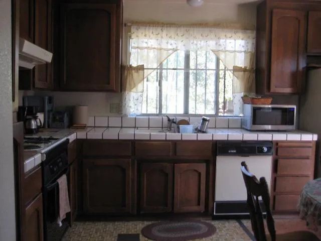 a kitchen with a sink a stove and cabinets