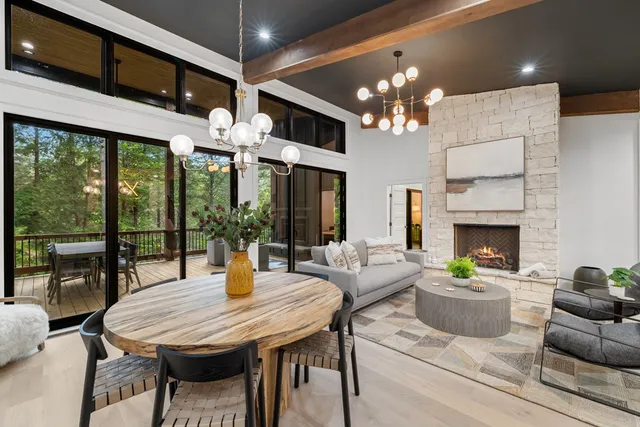 a view of a dining room with furniture a livingroom and chandelier