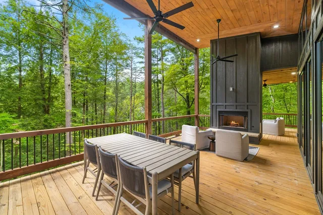a view of a patio with a table chairs and a backyard