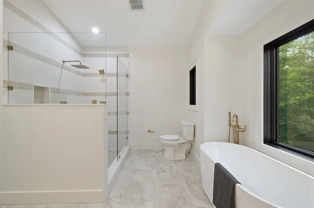 a bathroom with a shower and toilet