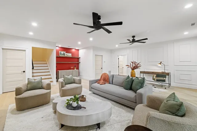 a living room with furniture and kitchen view