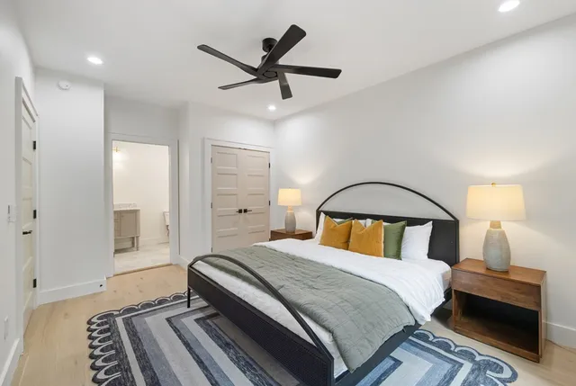 a bedroom with a large bed and a window