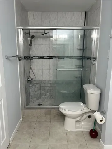 a bathroom with a toilet and a shower