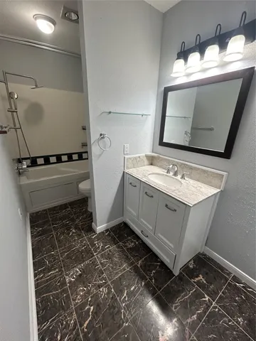 a utility room with a stove a sink and dishwasher