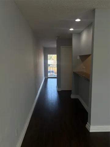 a view of hallway with wooden floor