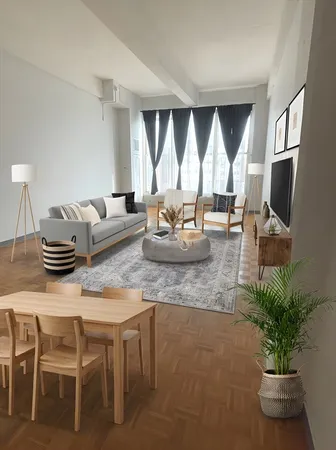 a living room with furniture and a potted plant