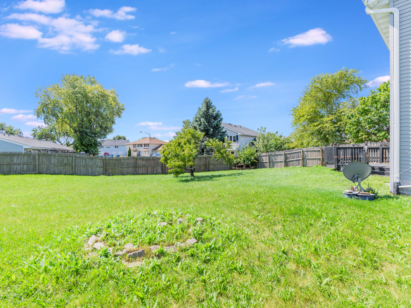 2433 Caton Crest Court Crest Hill, IL 60403 - Photo 16 of 18 a backyard of a house with lots of green space and outdoor seating
