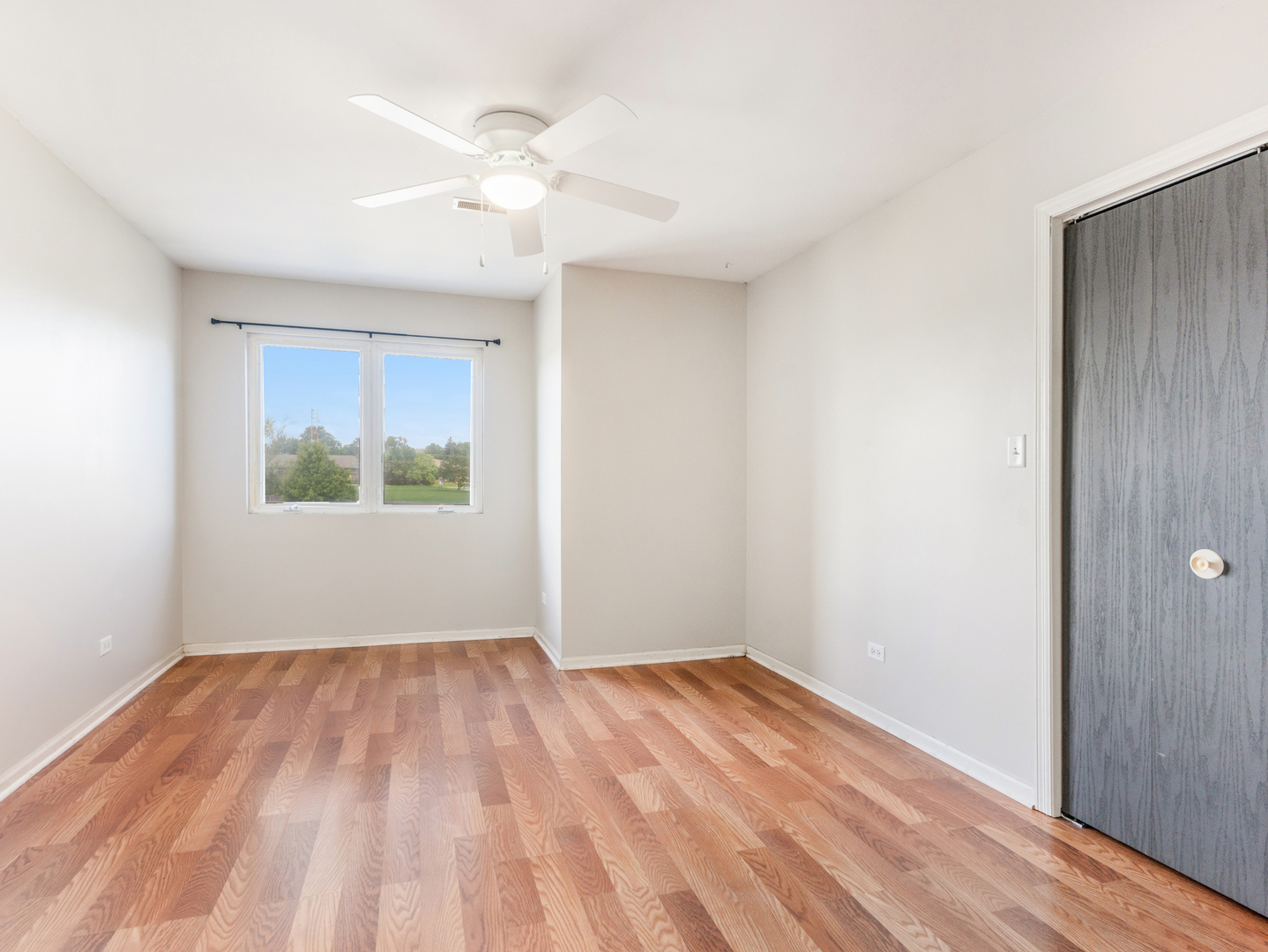 2433 Caton Crest Court Crest Hill, IL 60403 - Photo 10 of 18 a view of an empty room with wooden floor and a window