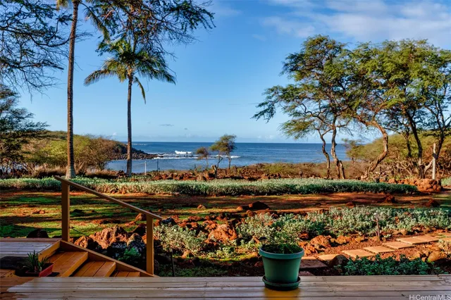 a kitchen with stainless steel appliances granite countertop a table chairs stove and refrigerator