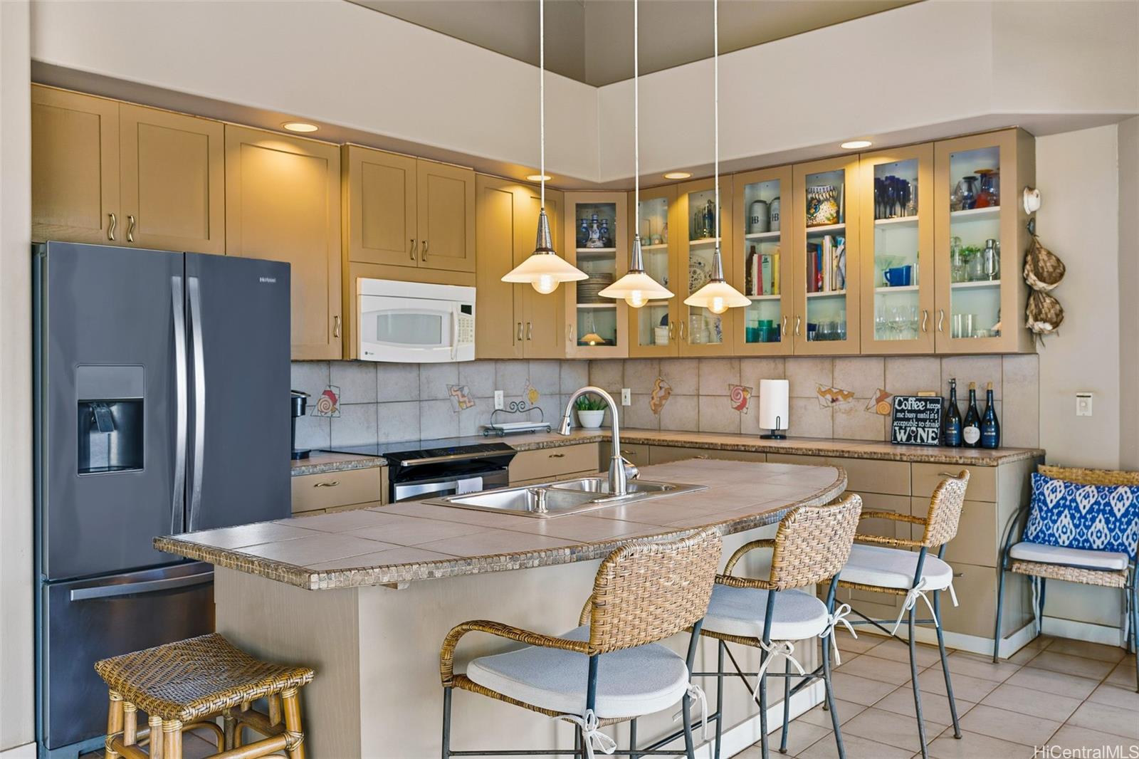 4720 Pohakuloa Road Maunaloa, HI 96770 - Photo 6 of 20 a kitchen with stainless steel appliances granite countertop a table chairs stove and refrigerator