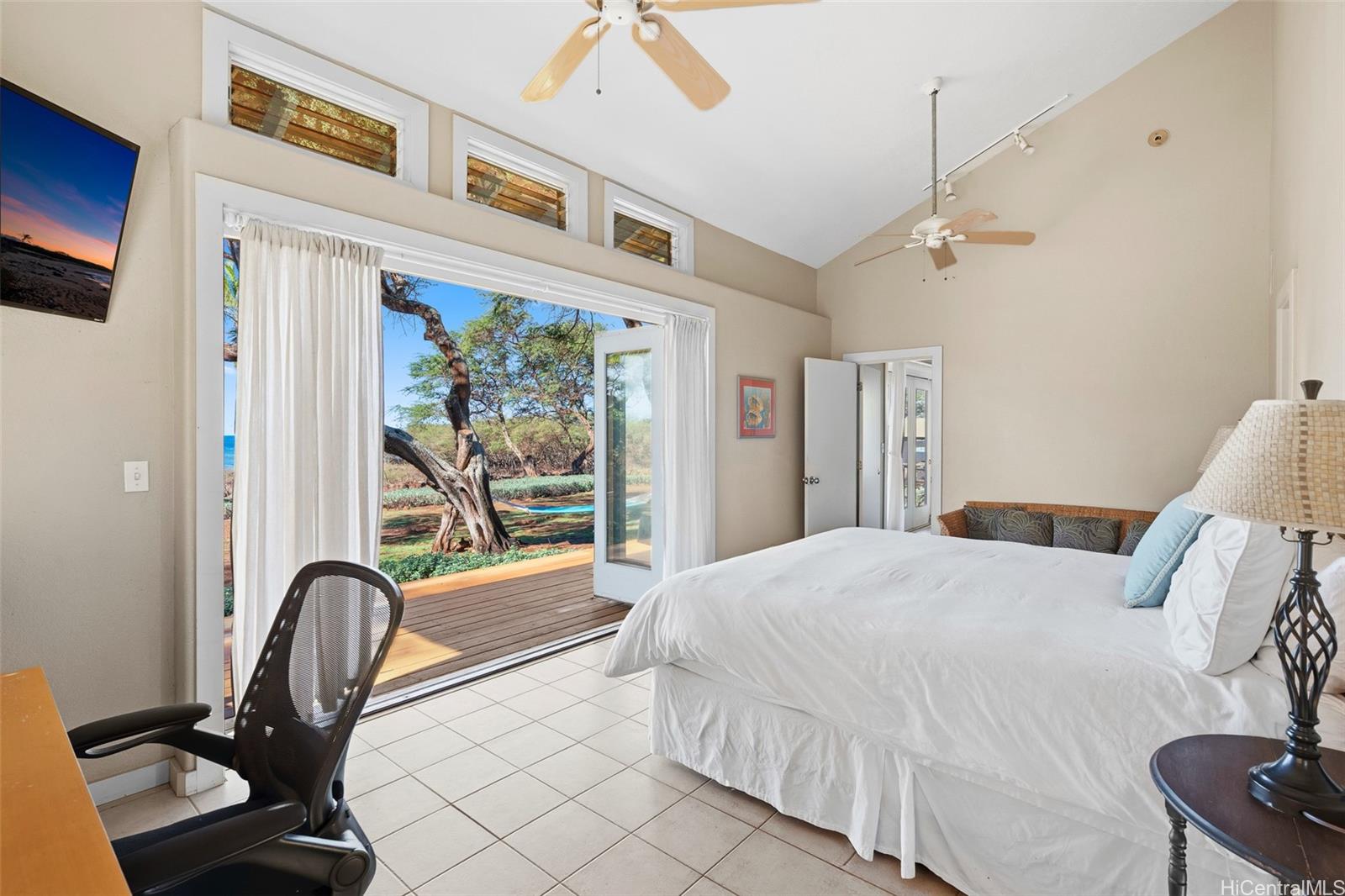 4720 Pohakuloa Road Maunaloa, HI 96770 - Photo 7 of 20 a bedroom with a bed a table and a large window