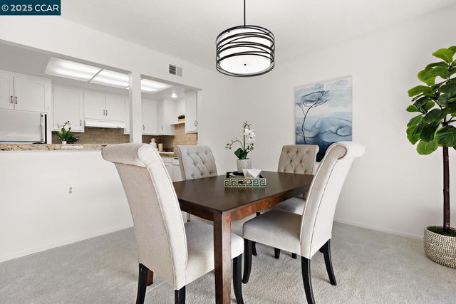a dining room with furniture window and wooden floor