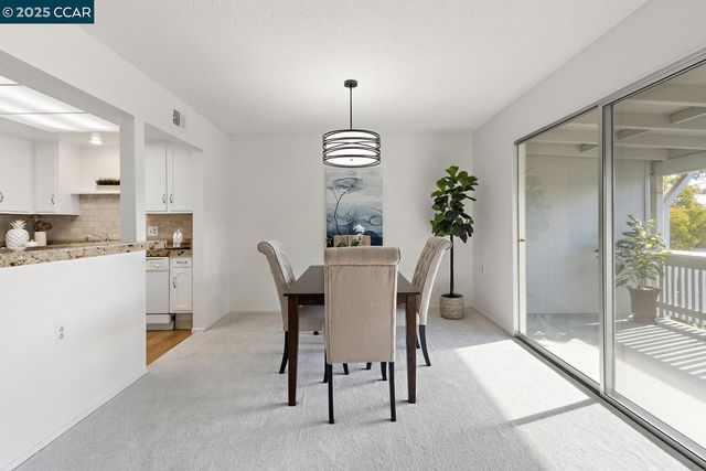 a dining room with furniture window and outside view