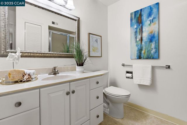a bathroom with a toilet a sink and a mirror