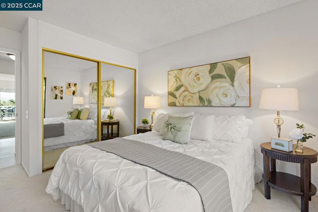 a bedroom with a bed and a painting on the wall