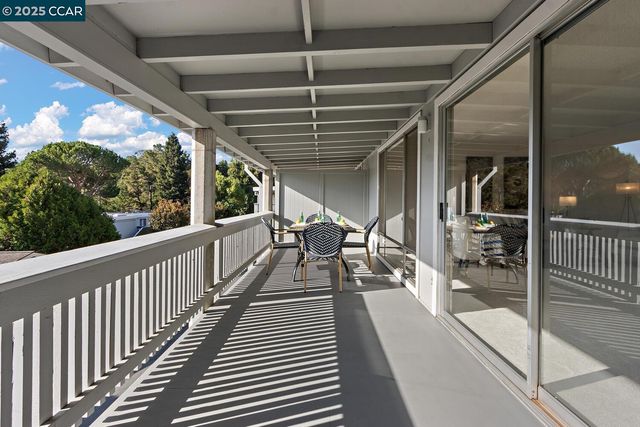 a view of a house with yard and sitting area