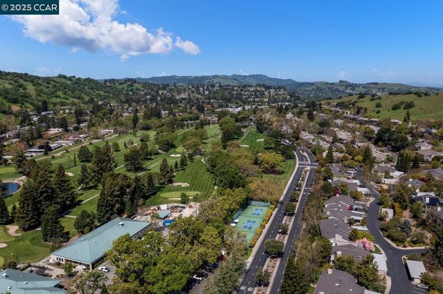 an aerial view of a house with a yard