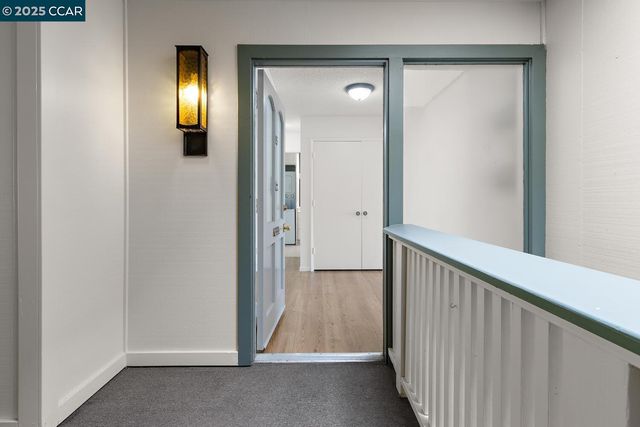 a view of a hallway with a door and a mirror