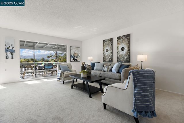 a living room with furniture and a lamp