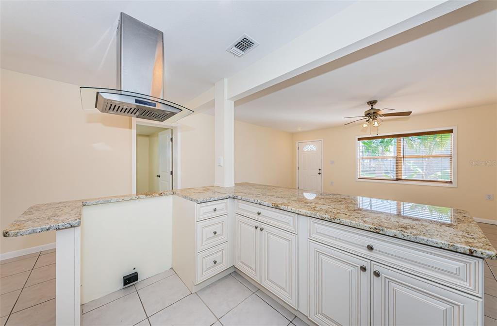 713 Pruitt Drive Madeira Beach, FL 33708 - Photo 14 of 62 a bathroom with a granite countertop sink a mirror and a bathtub