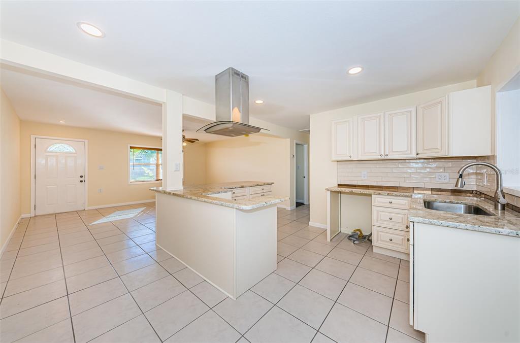 713 Pruitt Drive Madeira Beach, FL 33708 - Photo 15 of 62 a kitchen with a sink a stove and cabinets