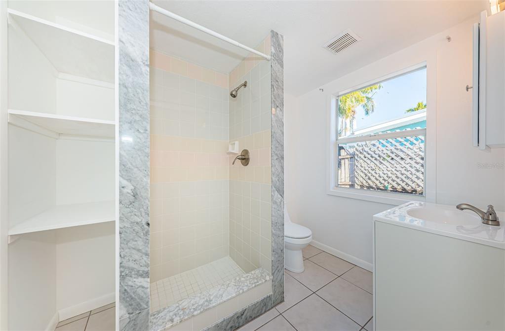 713 Pruitt Drive Madeira Beach, FL 33708 - Photo 24 of 62 a bathroom with a shower and a toilet