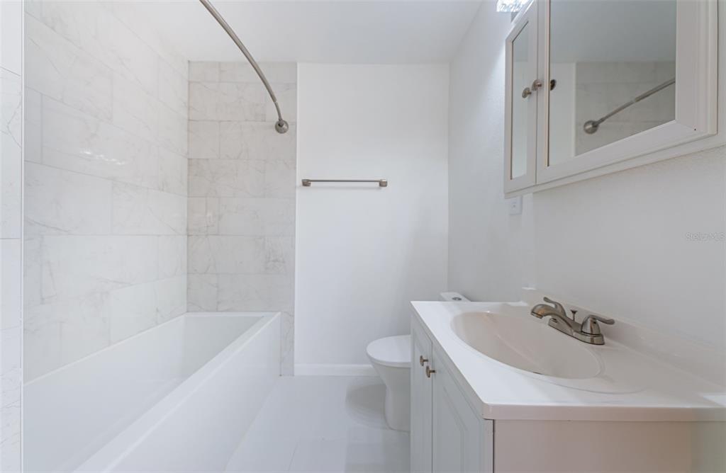 713 Pruitt Drive Madeira Beach, FL 33708 - Photo 29 of 62 a bathroom with a sink a toilet and shower