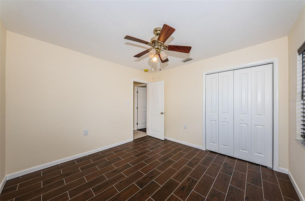 713 Pruitt Drive Madeira Beach, FL 33708 - Photo 33 of 62 a view of a room with wooden floor and a ceiling fan