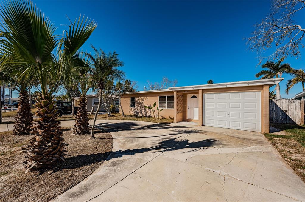 713 Pruitt Drive Madeira Beach, FL 33708 - Photo 41 of 62 a front view of a house with garden