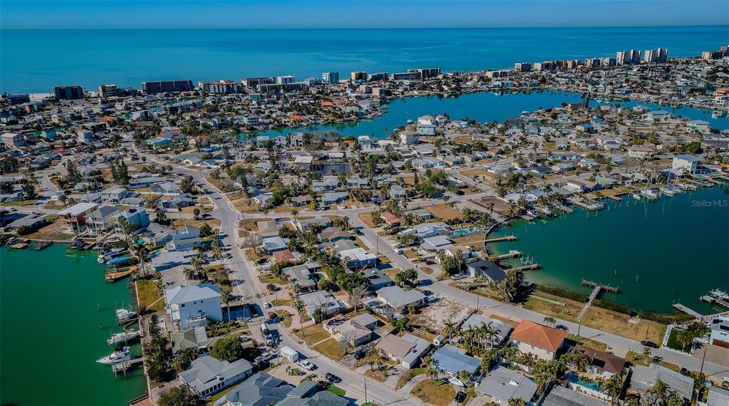 713 Pruitt Drive Madeira Beach, FL 33708 - Photo 46 of 62 an aerial view of a city with lots of residential buildings and ocean view in back