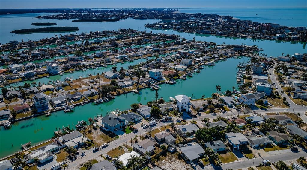 713 Pruitt Drive Madeira Beach, FL 33708 - Photo 49 of 62 an aerial view of a city with lots of residential buildings ocean and mountain view in back