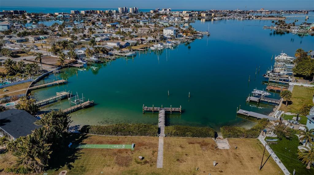 713 Pruitt Drive Madeira Beach, FL 33708 - Photo 55 of 62 an aerial view of a house with a yard and lake view